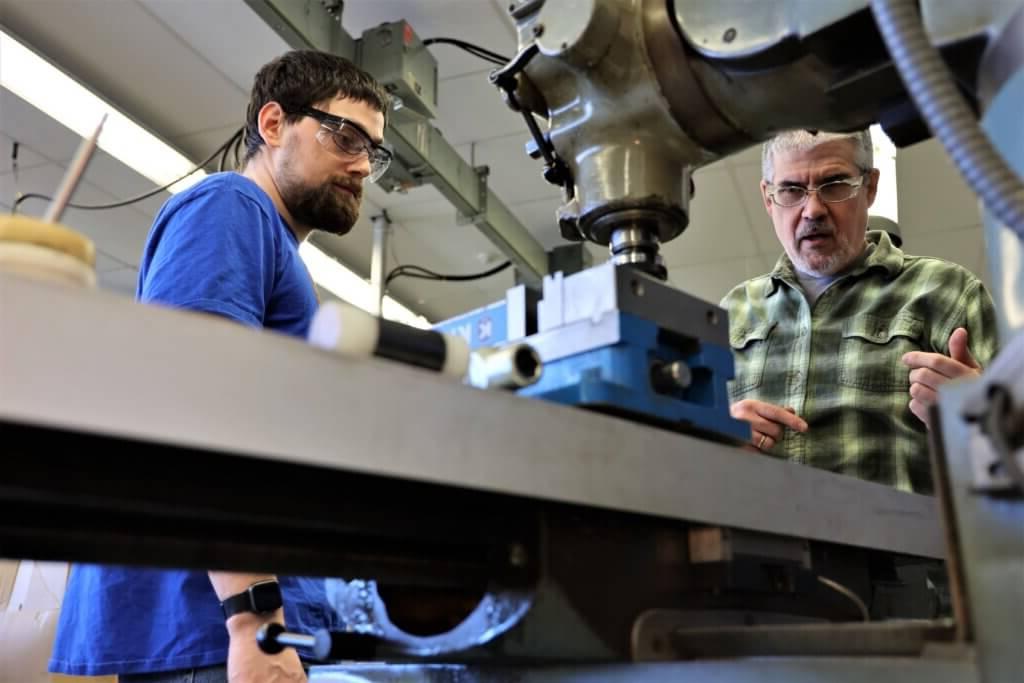 Professor Jeff Beltramo instructs a student on how to use equipment in the engineering programs lab